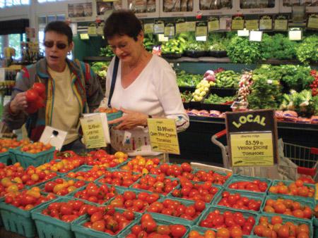 shoppers looking at tomoatos